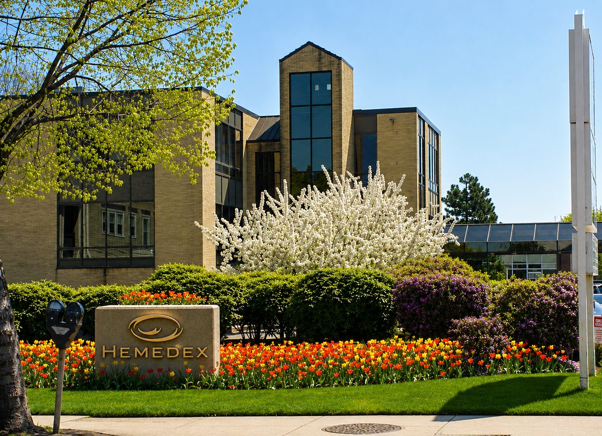 Hemedex headquarters in Waltham, Massachusetts — a modern office building with the Hemedex monument sign and spring tulips in the foreground